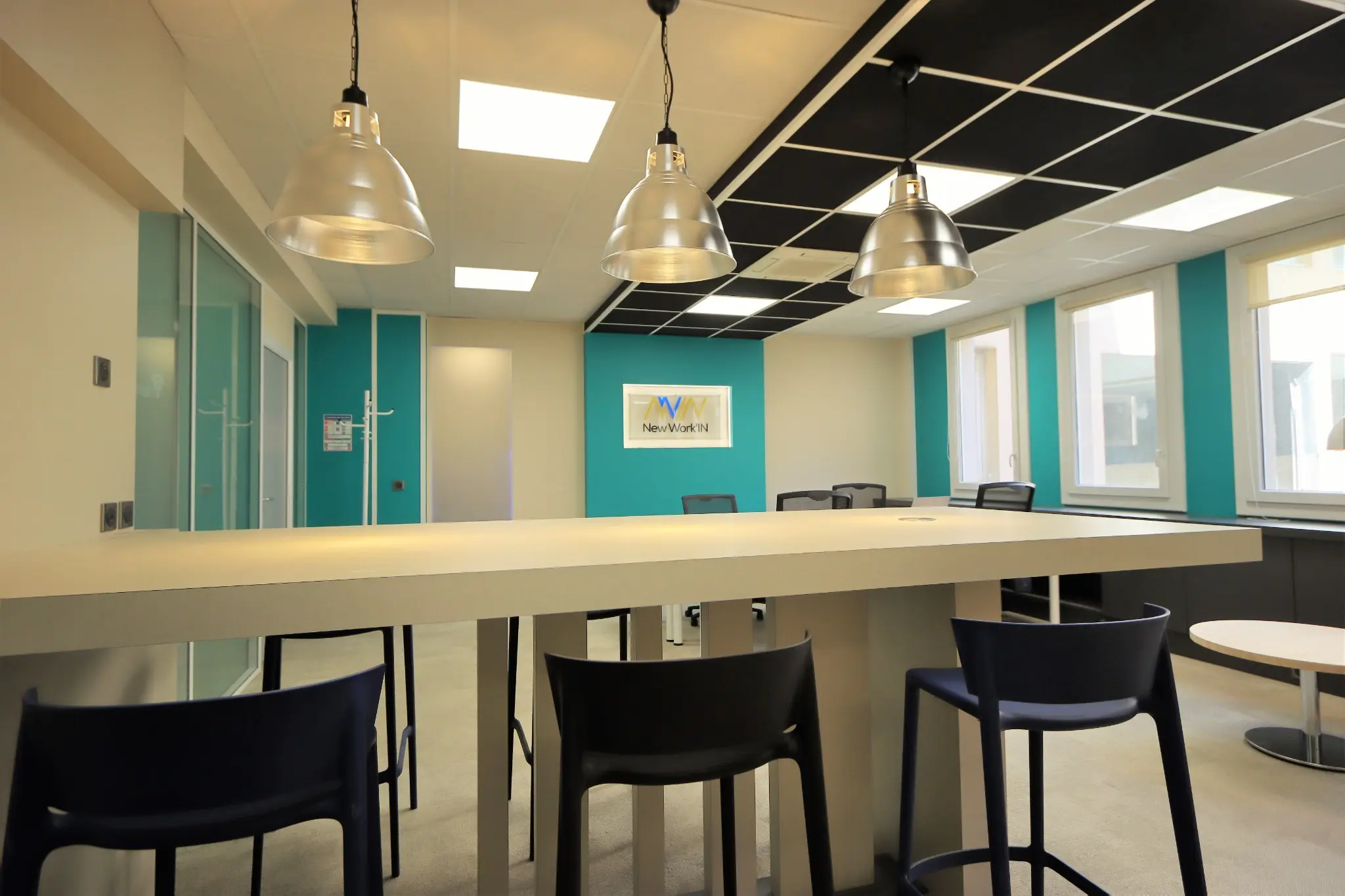 Espace de réunion turquoise avec table haute